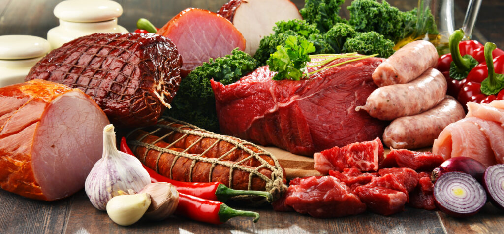 Variety of meat products including ham and sausages.